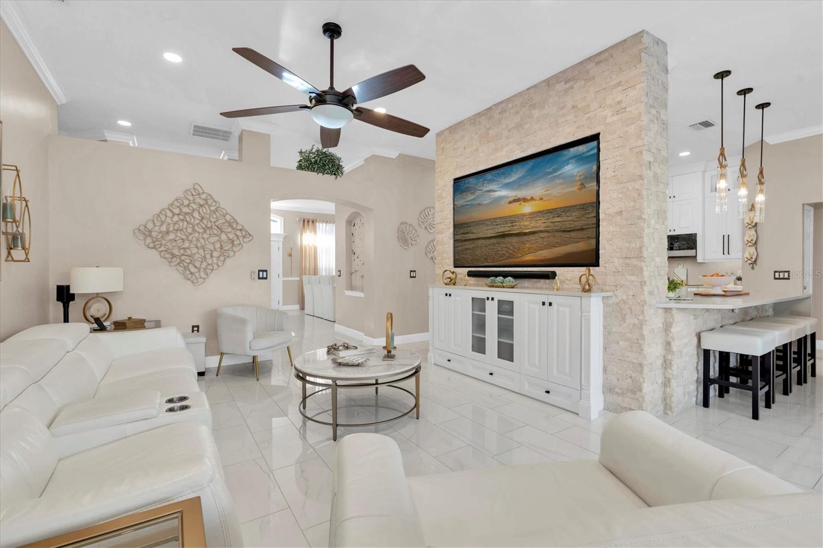 Great Room Showcasing Breakfast Bar and Custom Wall