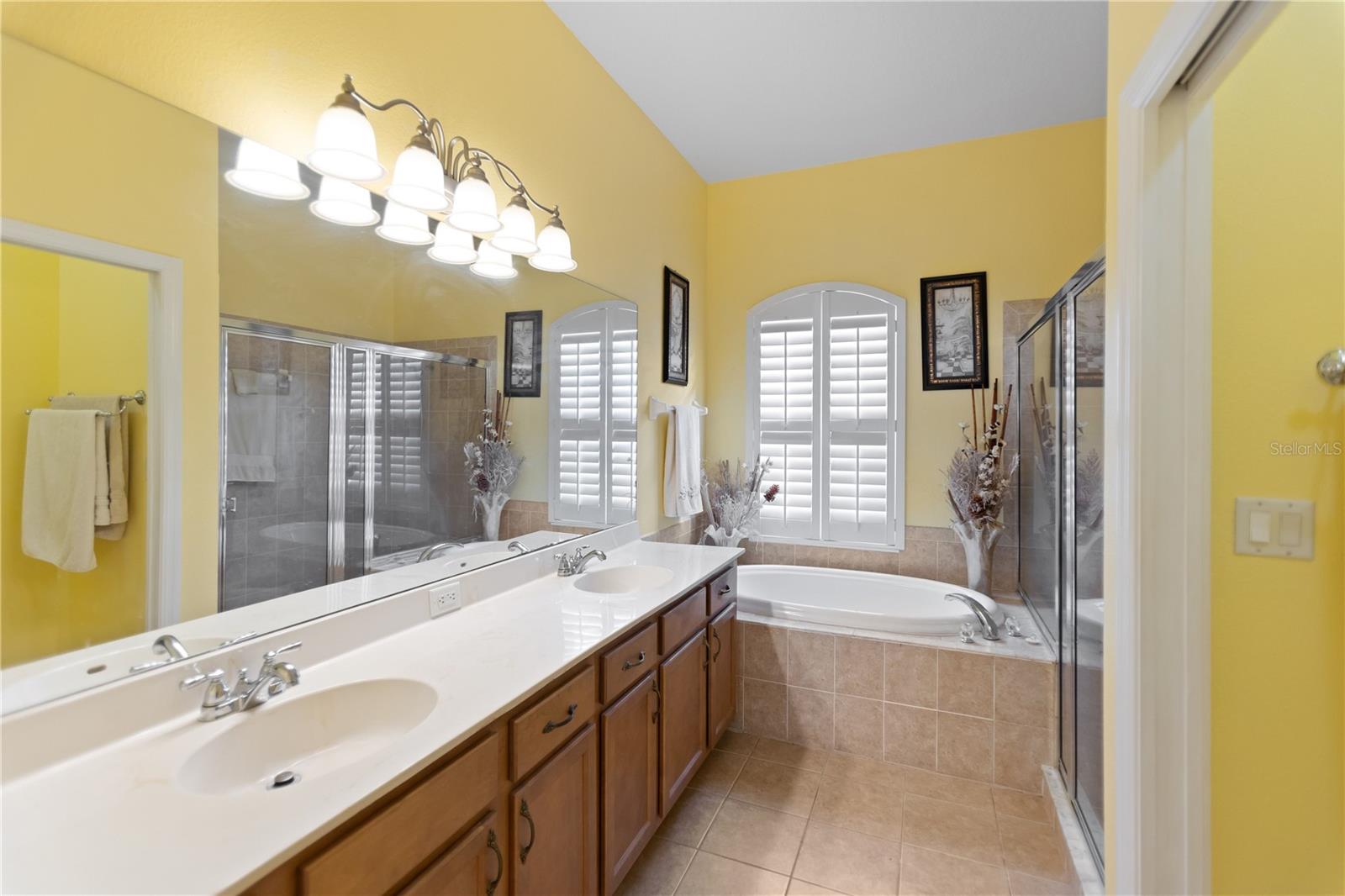 Primary bathroom with garden tub and separate shower, and dual sinks