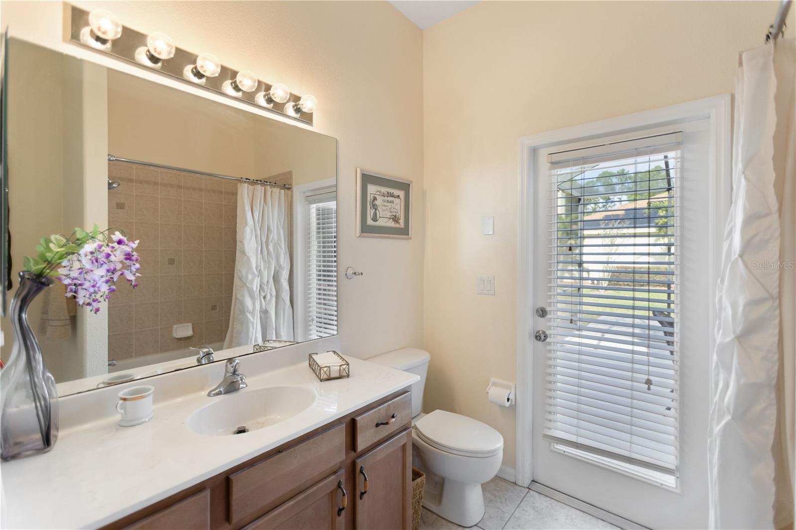 guest bathroom that leads out to the screened in lanai