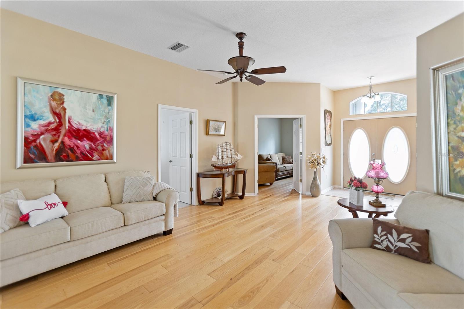 Great room with french doors that lead out to your covered and screened in lanai