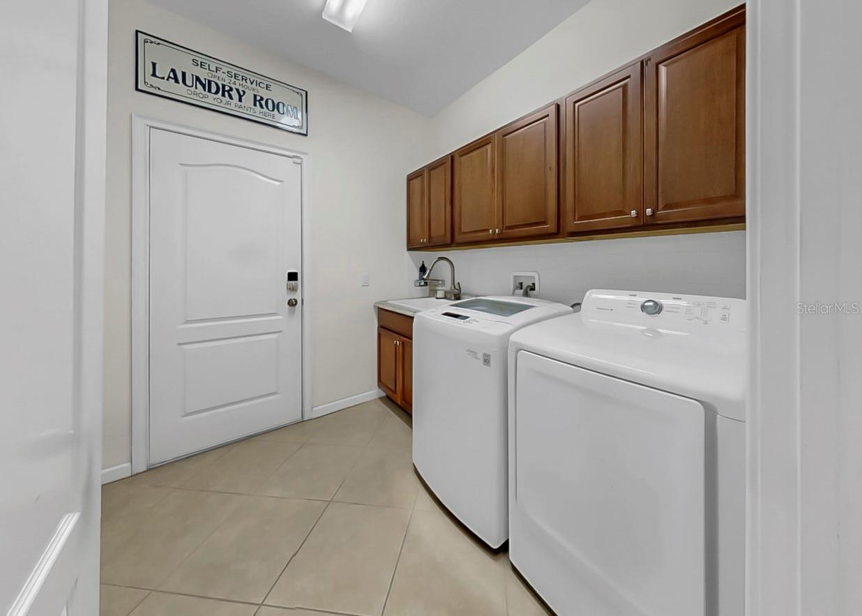 Laundry Room with Cabinetry and Utility Sink