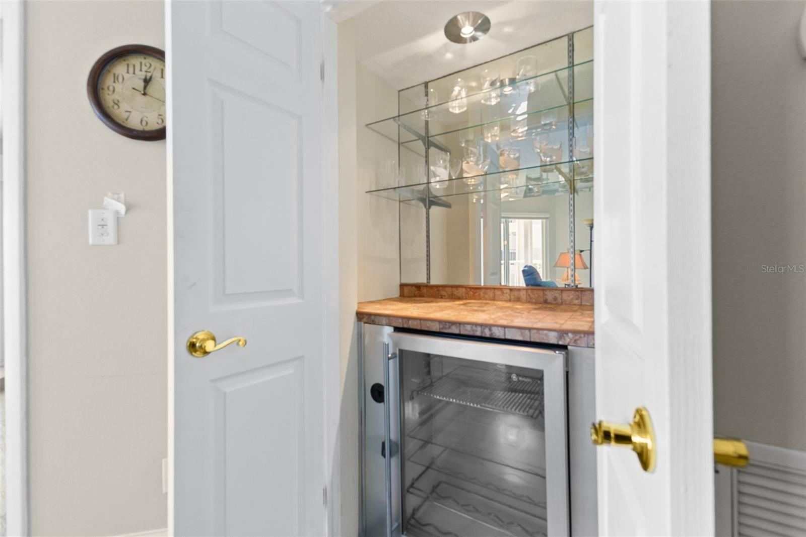 WET BAR WITH WINE REFRIGERATOR AND GLSS SHELVES TO KEEP ALLK YOU WINE GLASSES