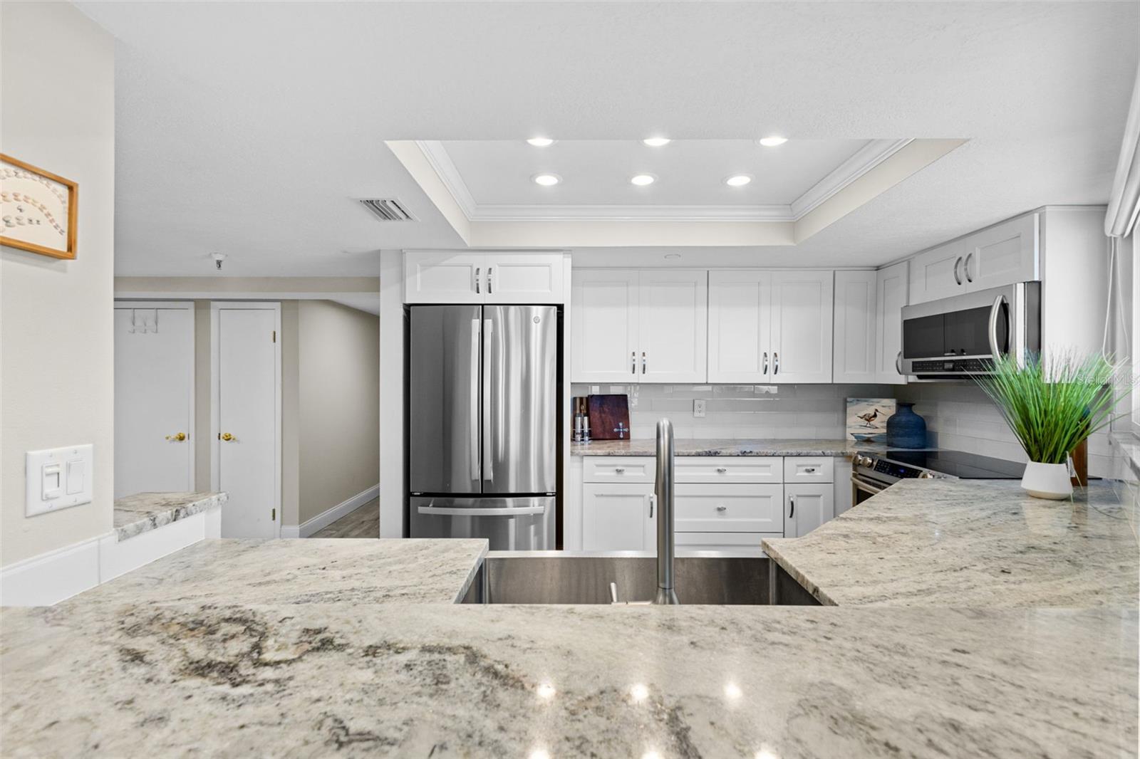VIEW OF THE KITCHEN FROM THE BREAKFAST BAR