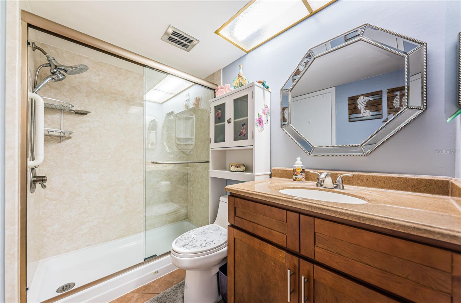 Updated bathroom with vanity, toilet and shower