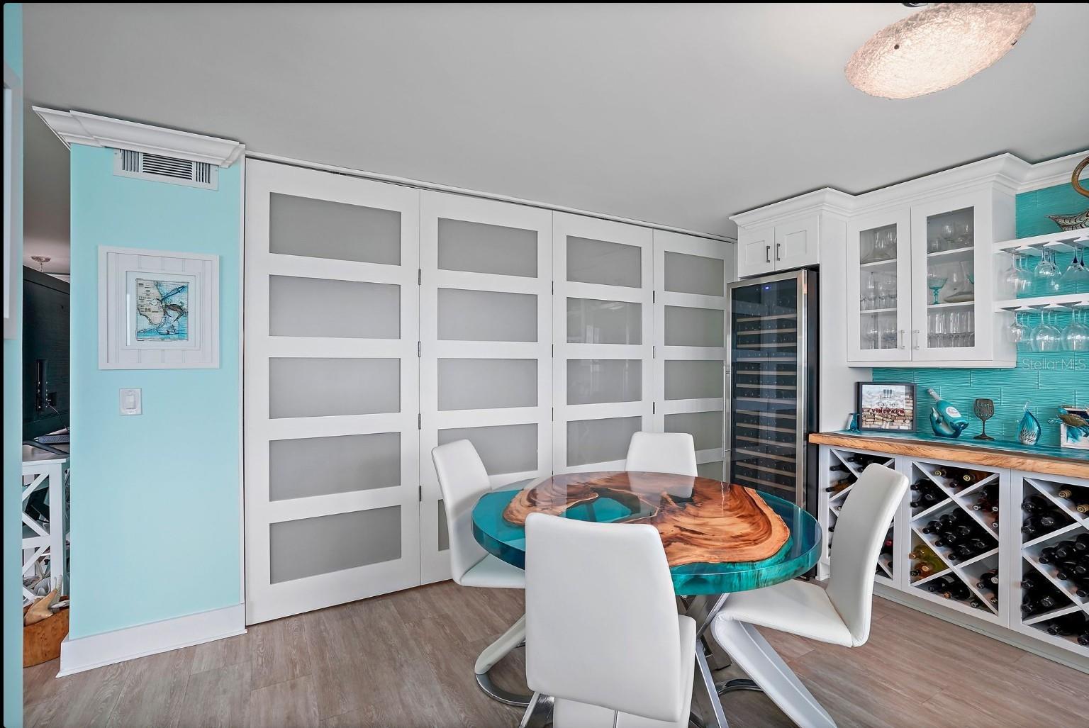 wine / card room with bifold doors closed making the master compleltly private