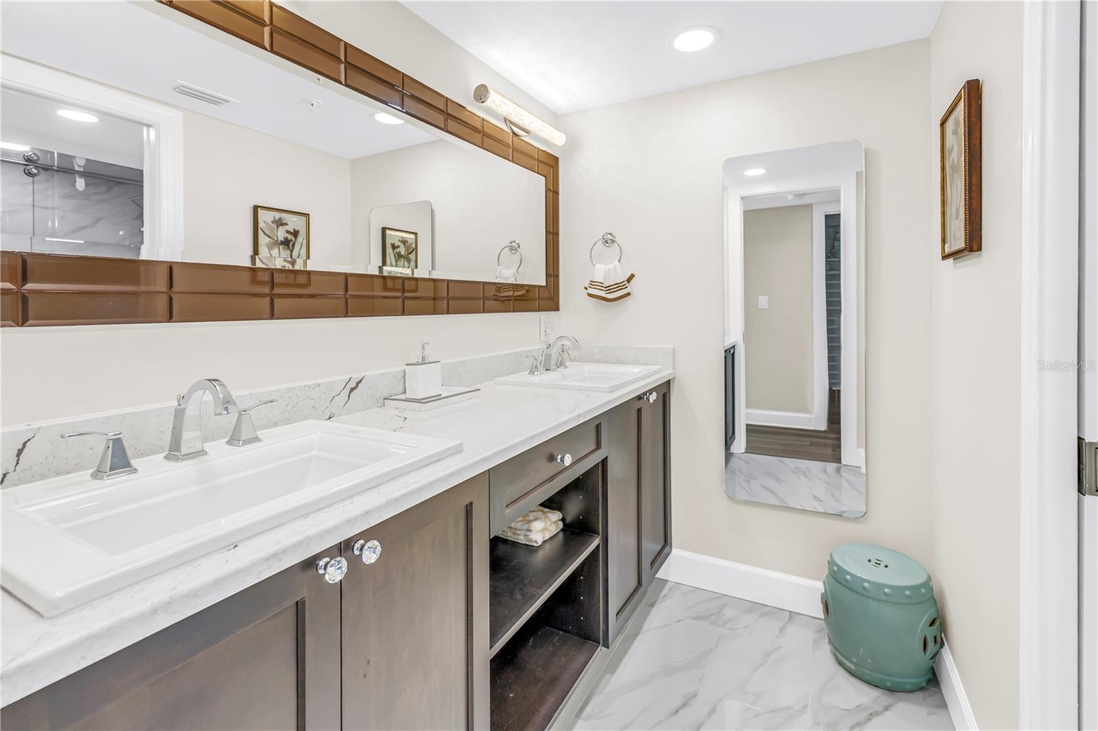 Primary En-Suite Features Quartz and Glass Enclosed Shower