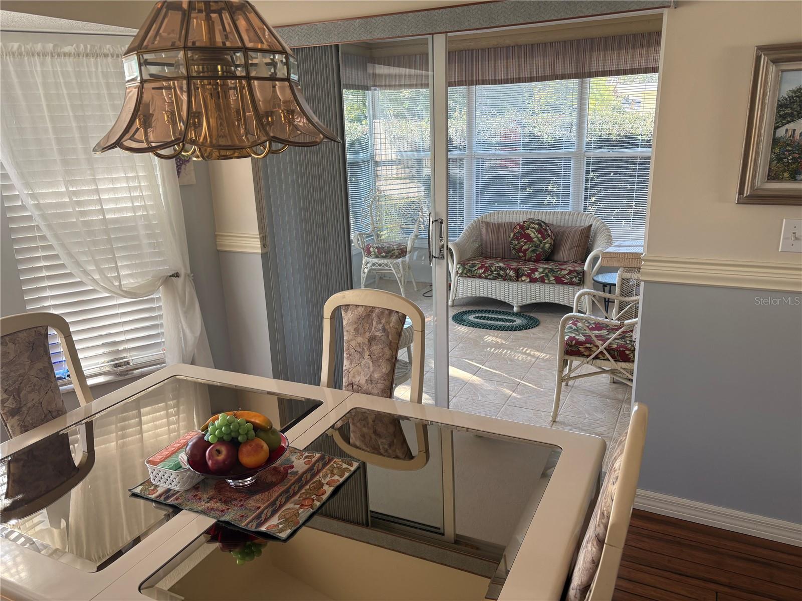 Dining area looking into finished enclosed Florida room.