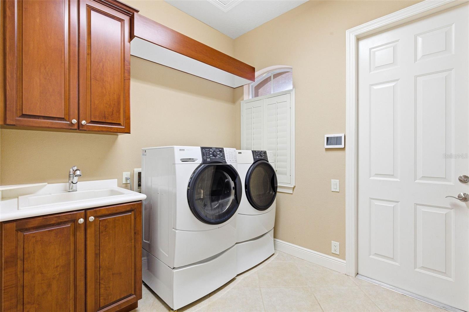 Indoor laundry room with cabinets and folding table