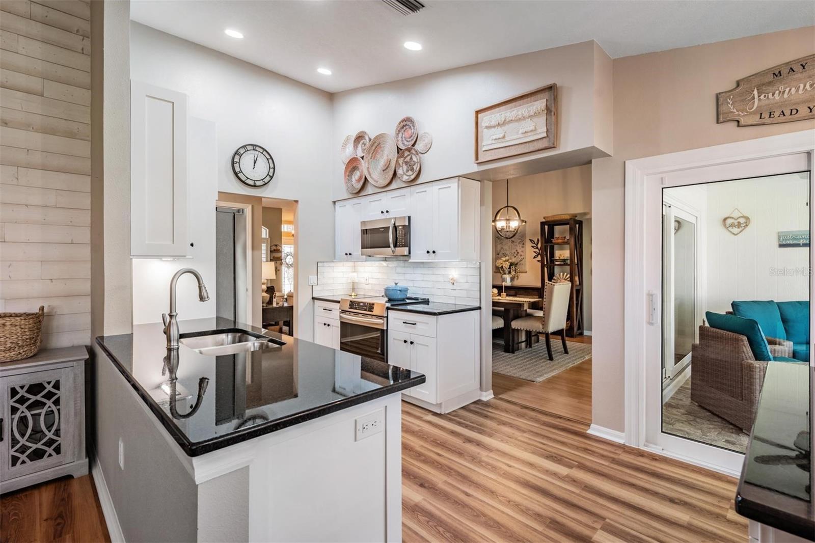 The family room views the kitchen and lanai