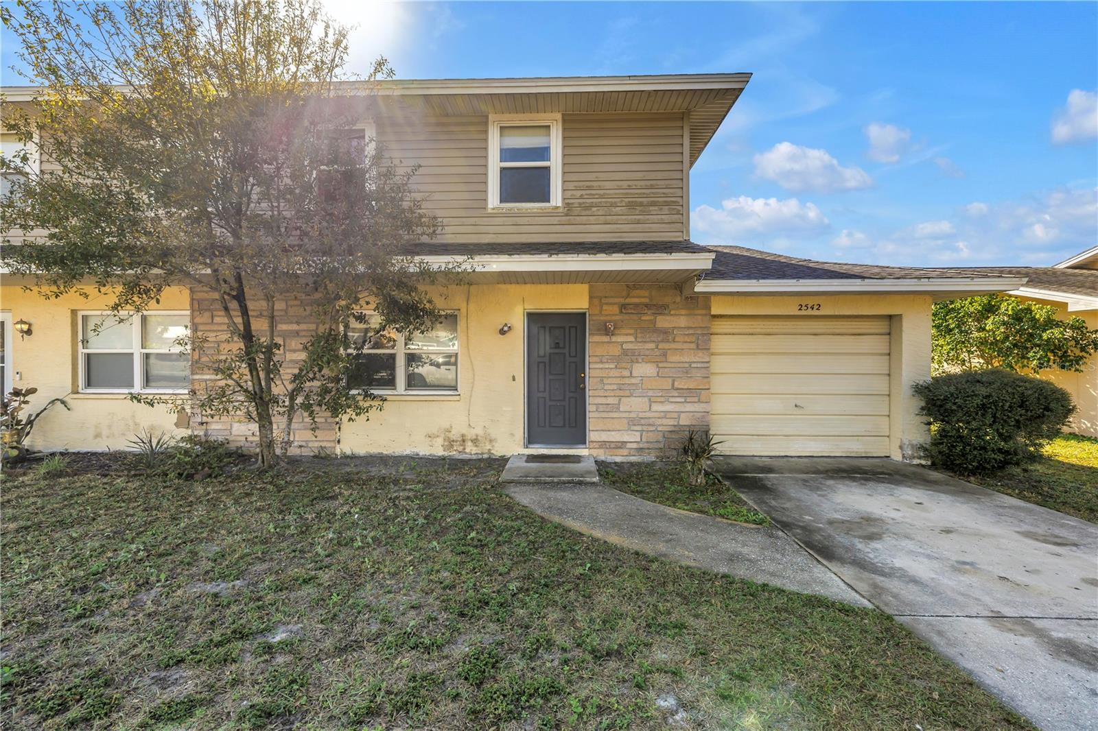 Front of home with separate driveway & attached garage