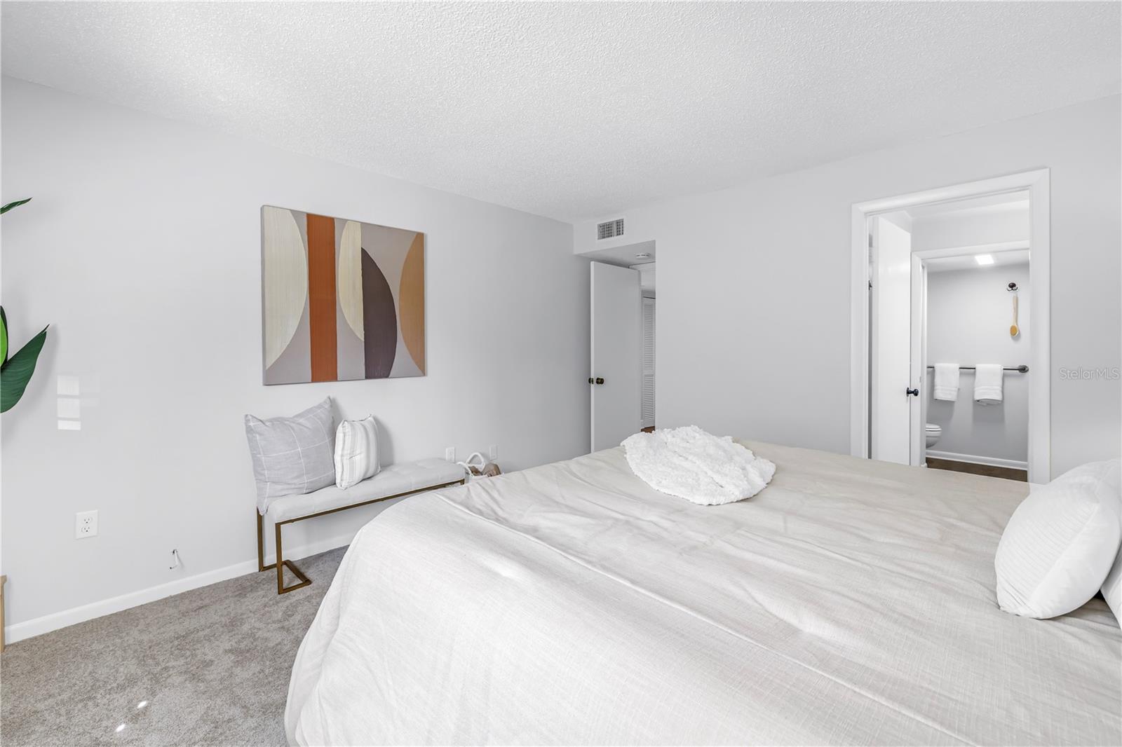 King Size Bed with End Tables and Plenty of Room for Furnishings