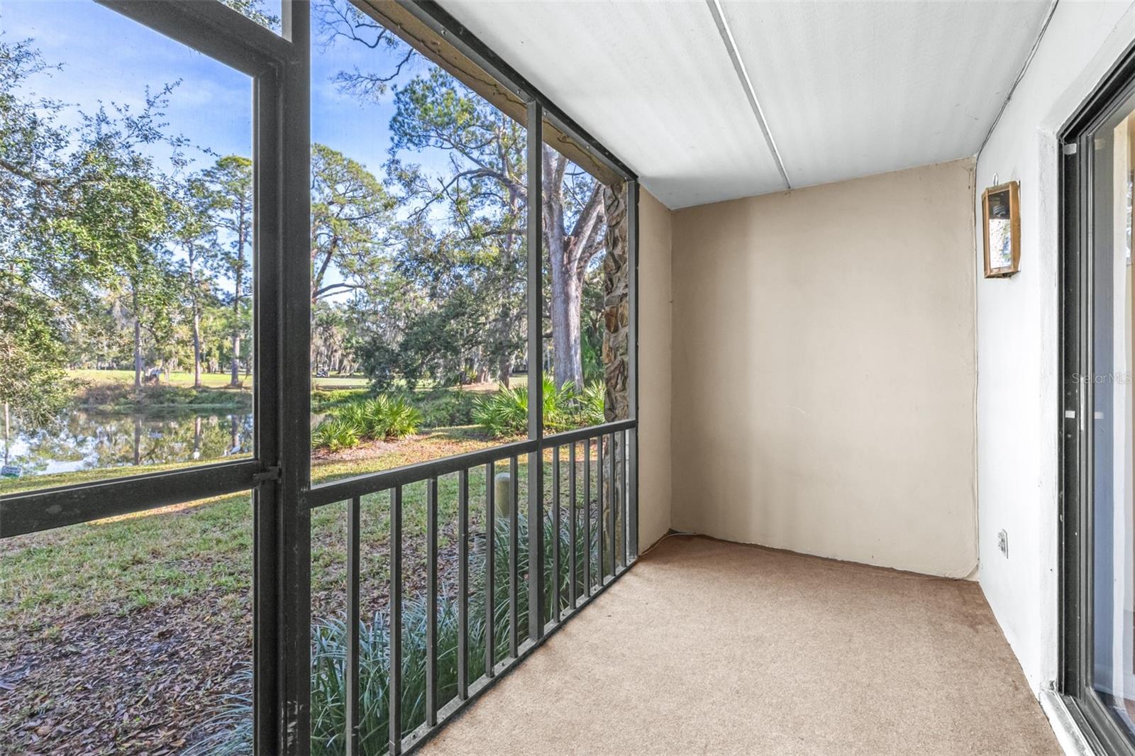 screened outdoor back patio looks over the water