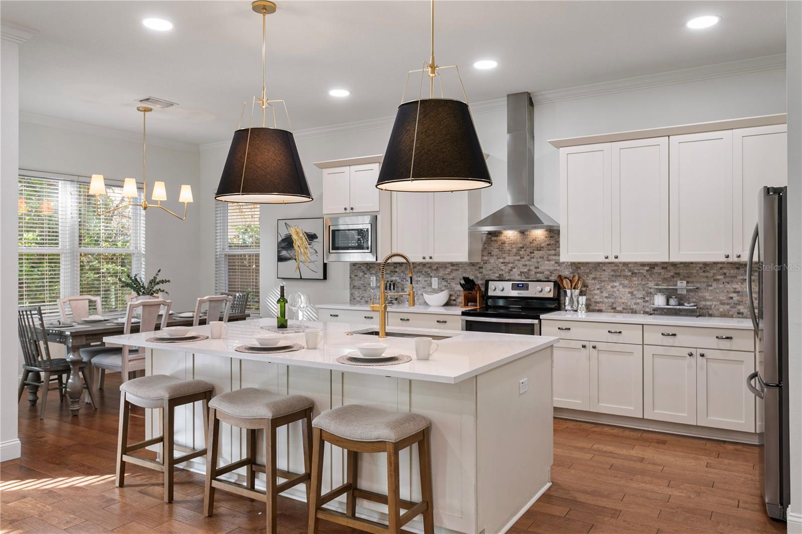 The spacious kitchen is the true heart of the home, designed for both everyday living and effortless entertainment.