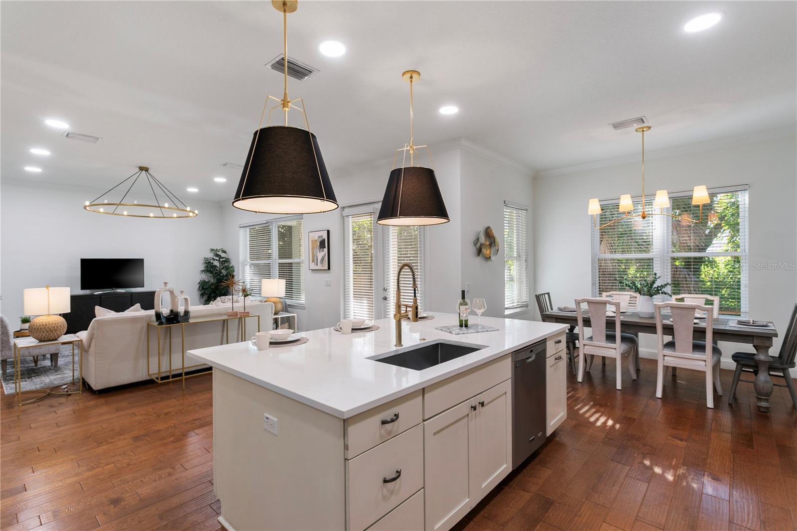 Enjoy extensive quartz countertops, a large center island, closet pantry, and an oversized breakfast nook overlooking the expansive Florida room and lush tropical backyard.
