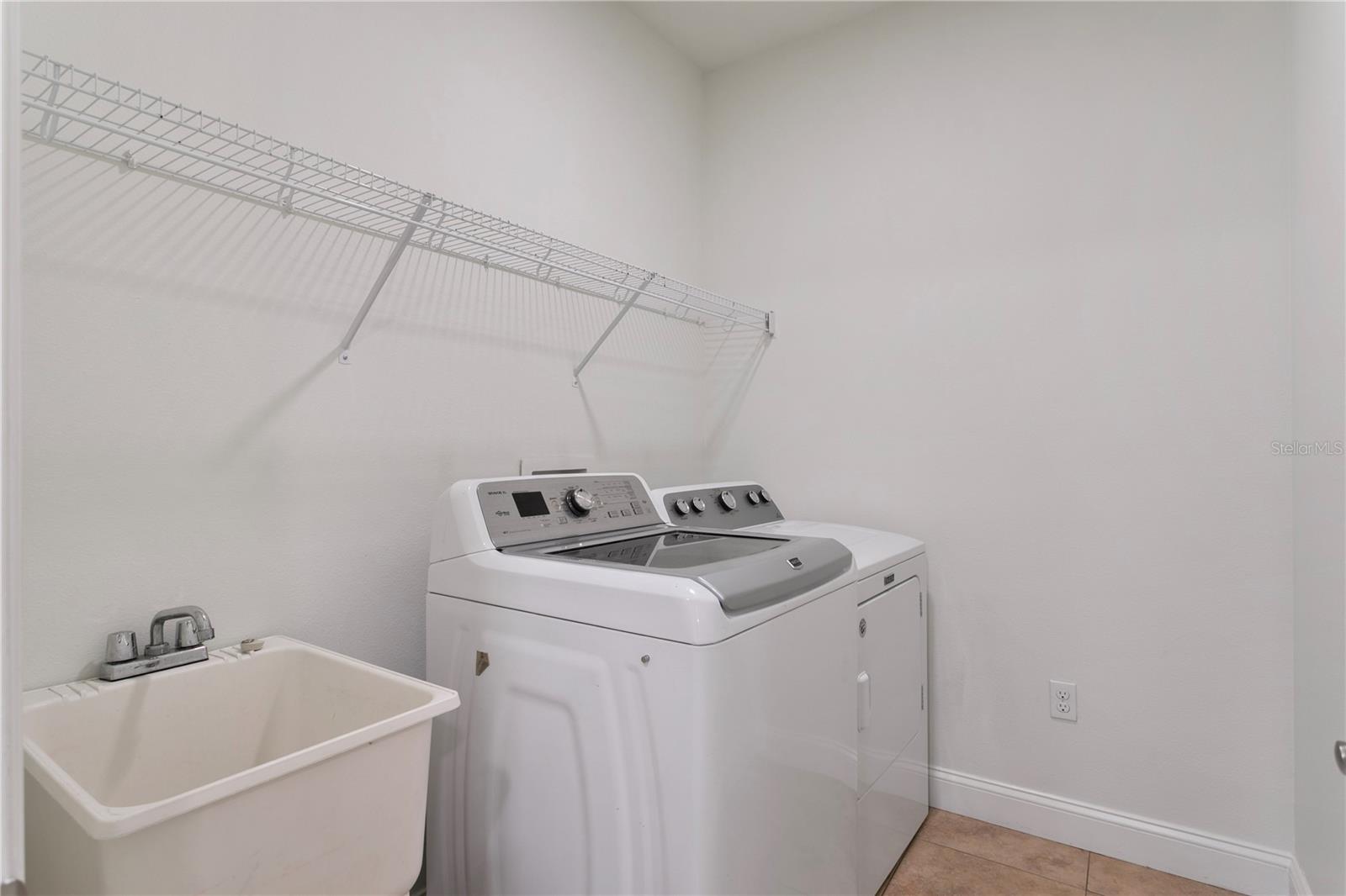 The laundry room is conveniently located on the second floor