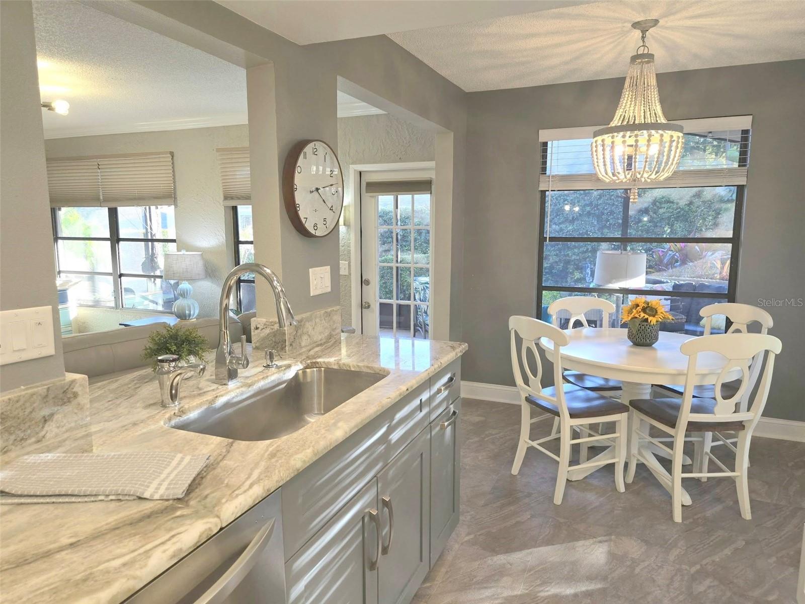 Easy care Sand & Surf lifetime tile flooring, and a deep sink in the open kitchen~