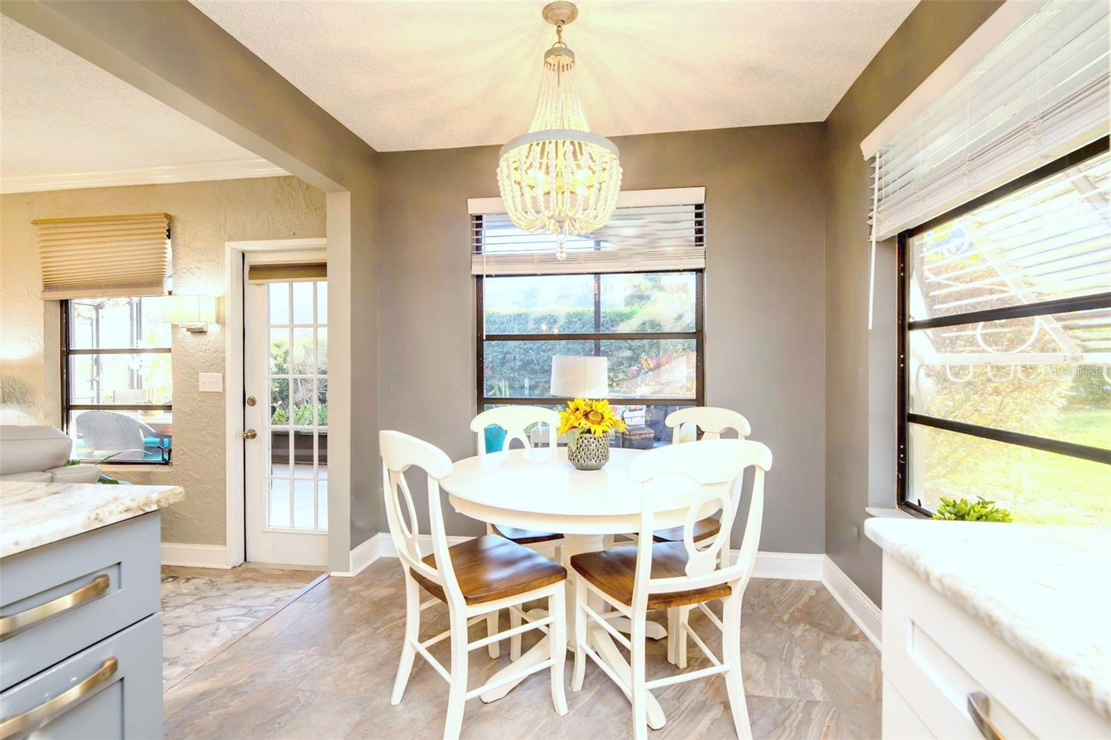 A just-right breakfast nook with a fun chandelier~