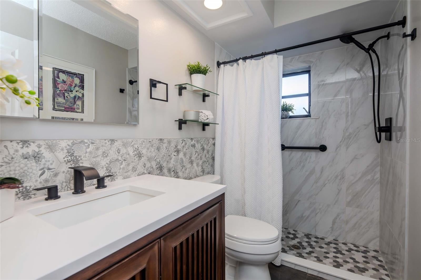 Newly renovated primary en suite with artful tiles & generous storage~
