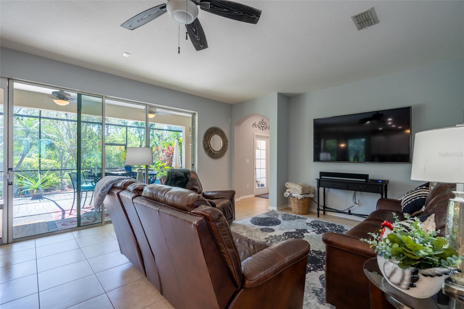 Triple sliders lead out to lanai from spacious living area.