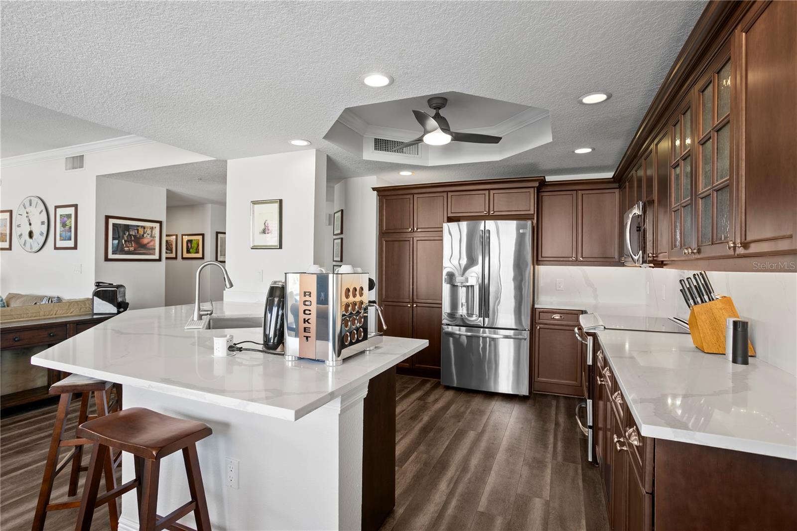 Updated kitchen with newer stainless-steel appliances and sleek quartz countertops