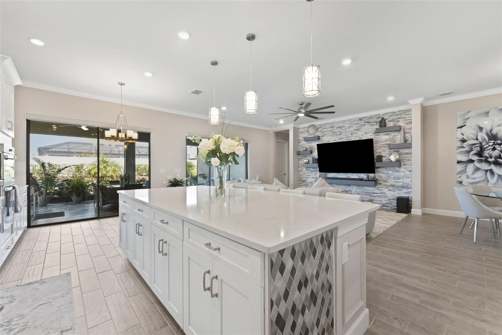 A large kitchen island with custom finishes offer plenty of room for a chef to have a buffet!