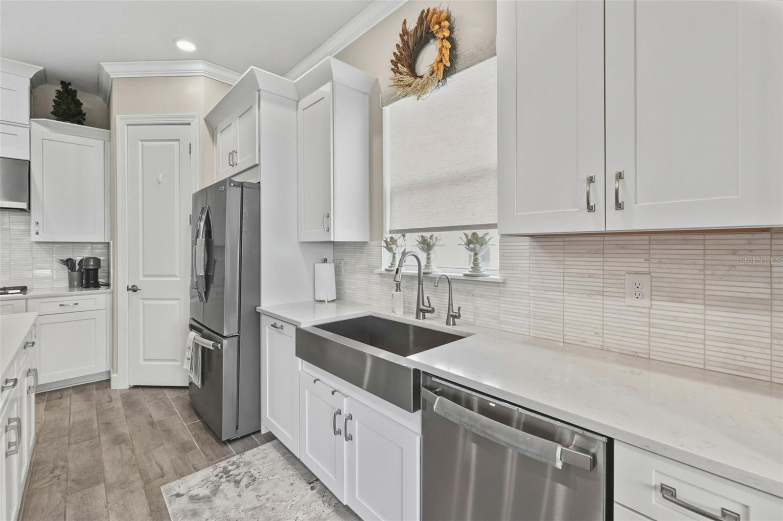 A large single stainless steel sink will hold plenty of chefs tools for cooking and the custom tile backsplash offers easy-to-clean clean up!