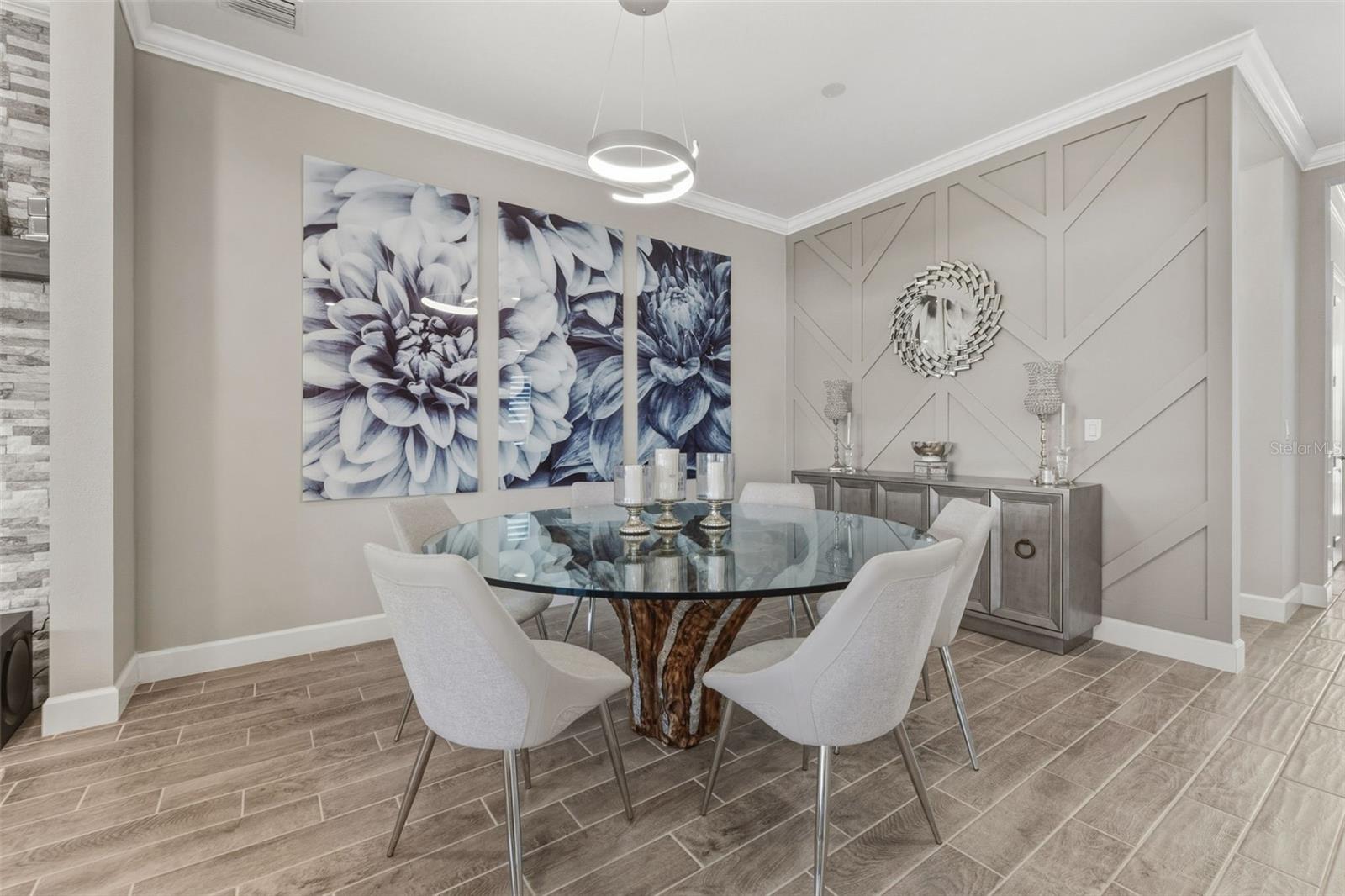 The custom wall and chandelier add depth and design to the dining area.