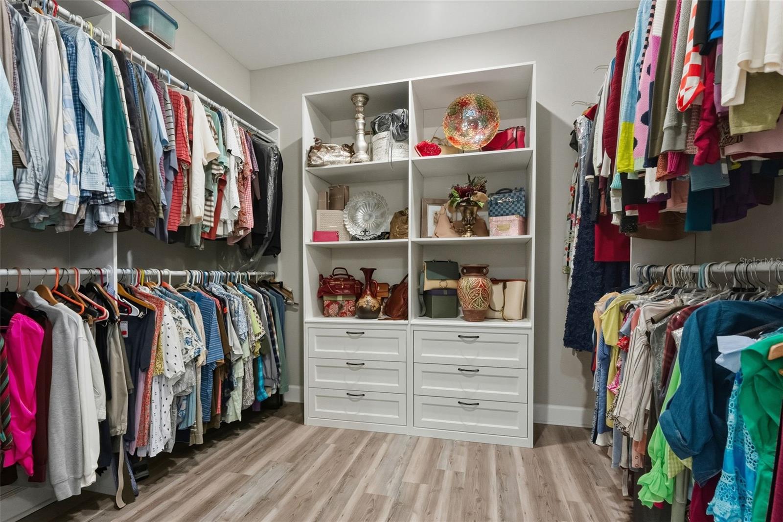 The primary walk-in closet has custom shelving too!