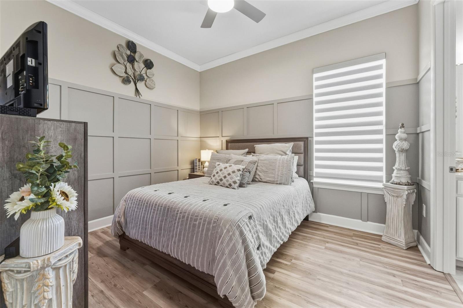 Bedroom 3 with a custom wall and private connected bathroom. There are also zebra shades to allow privacy and filtered light into the room.