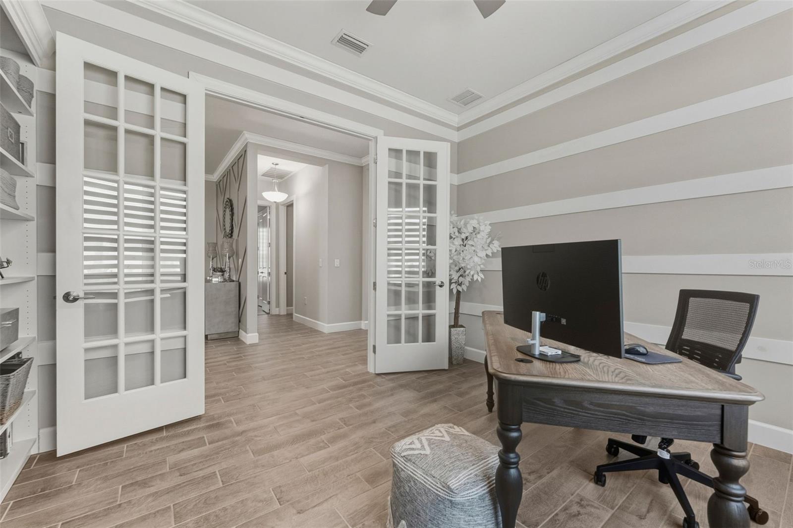 Double French Doors open into the den/office from the foyer.