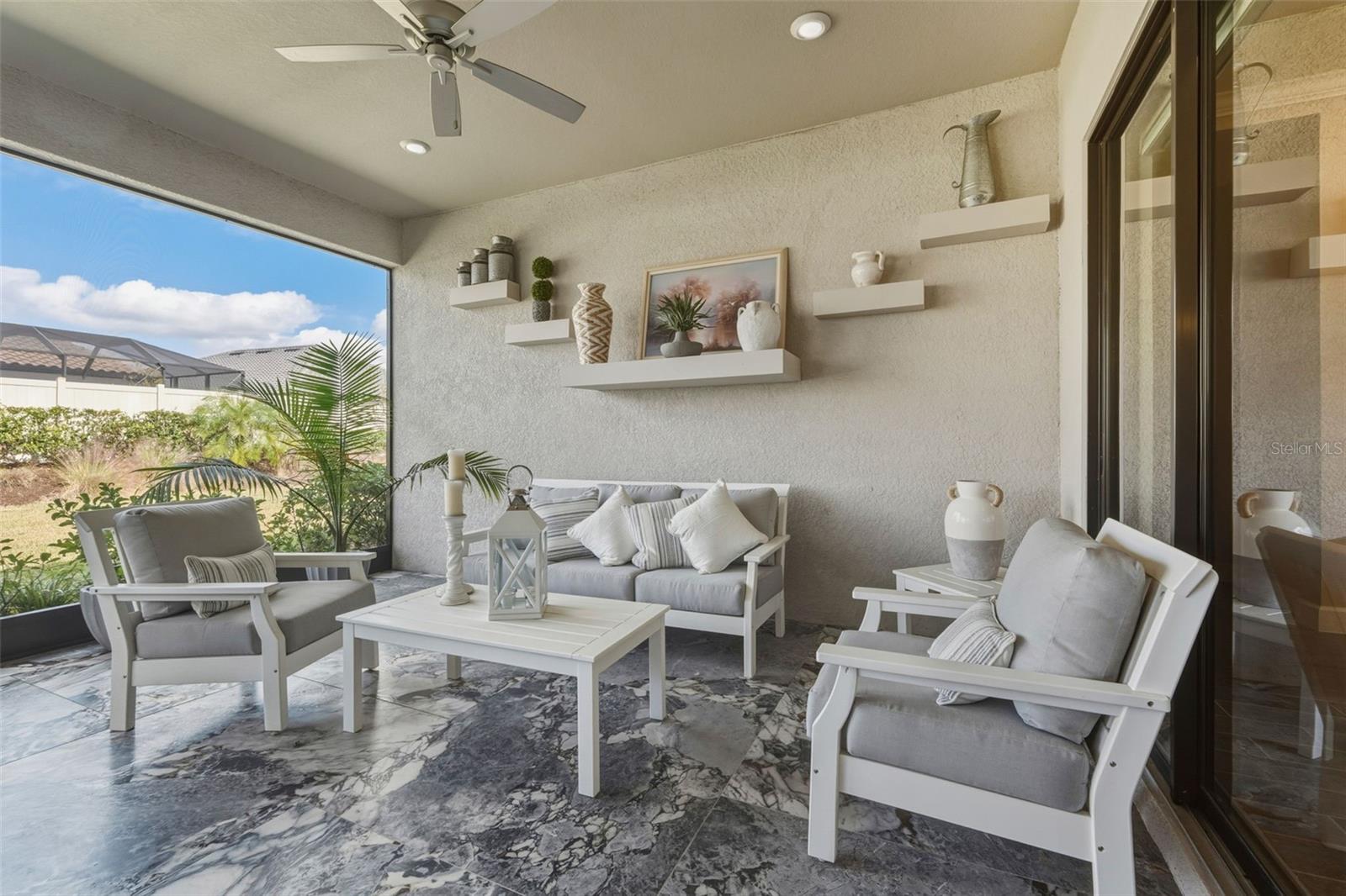 The screened-in lanai offers a comfortable living area with custom features!