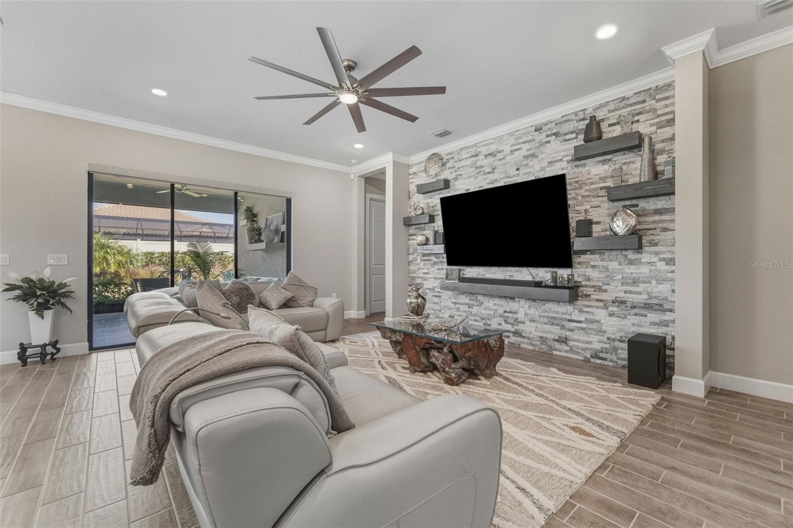 Custom wall, crown molding, and a stacked stone and shelving