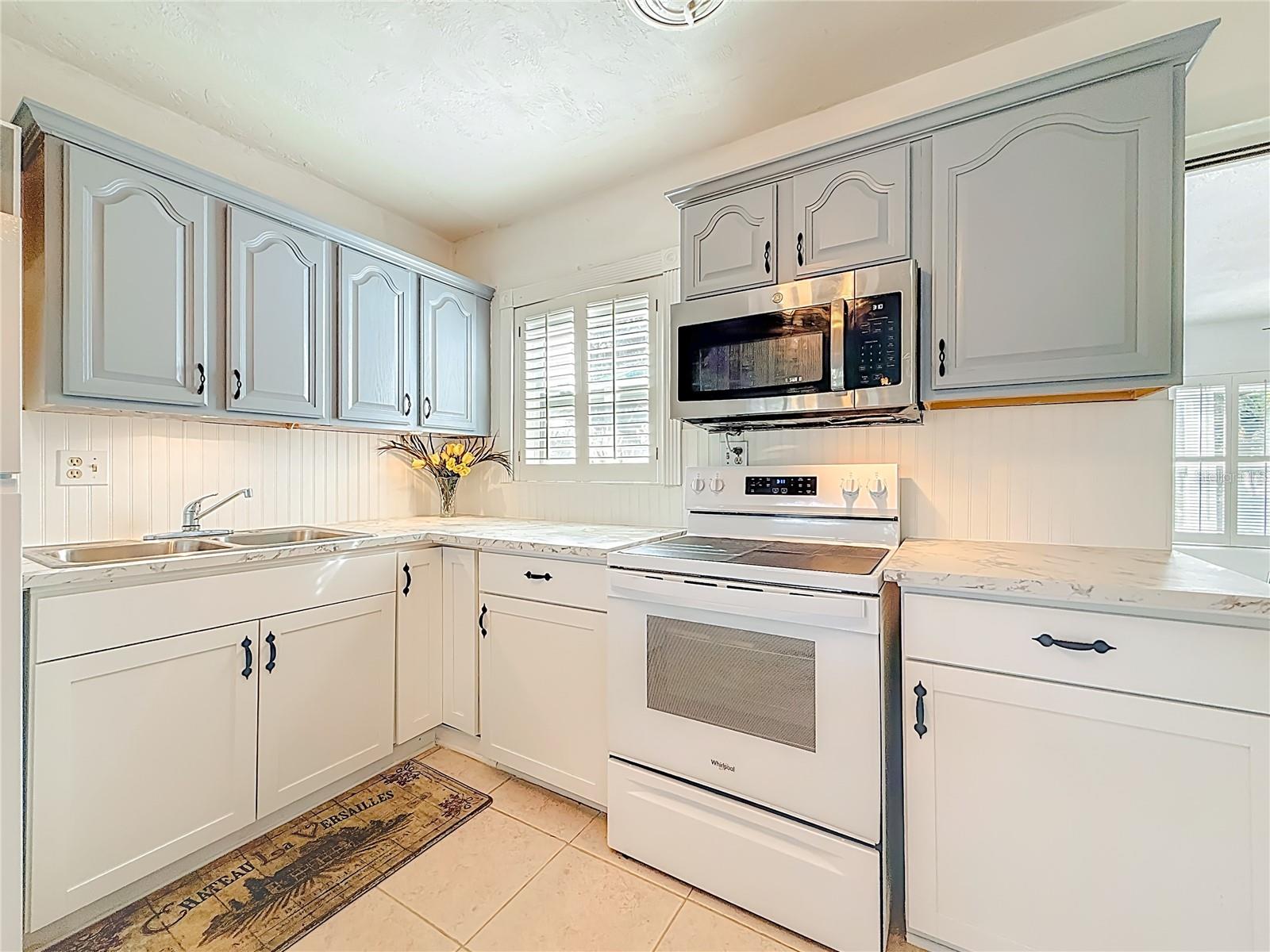 This is a closer look at the cooking and sink area in the kitchen