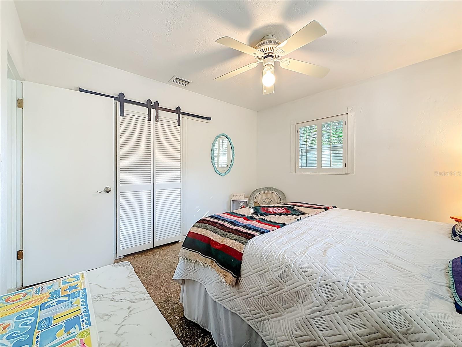 This bedroom has a nice sized closet in it.