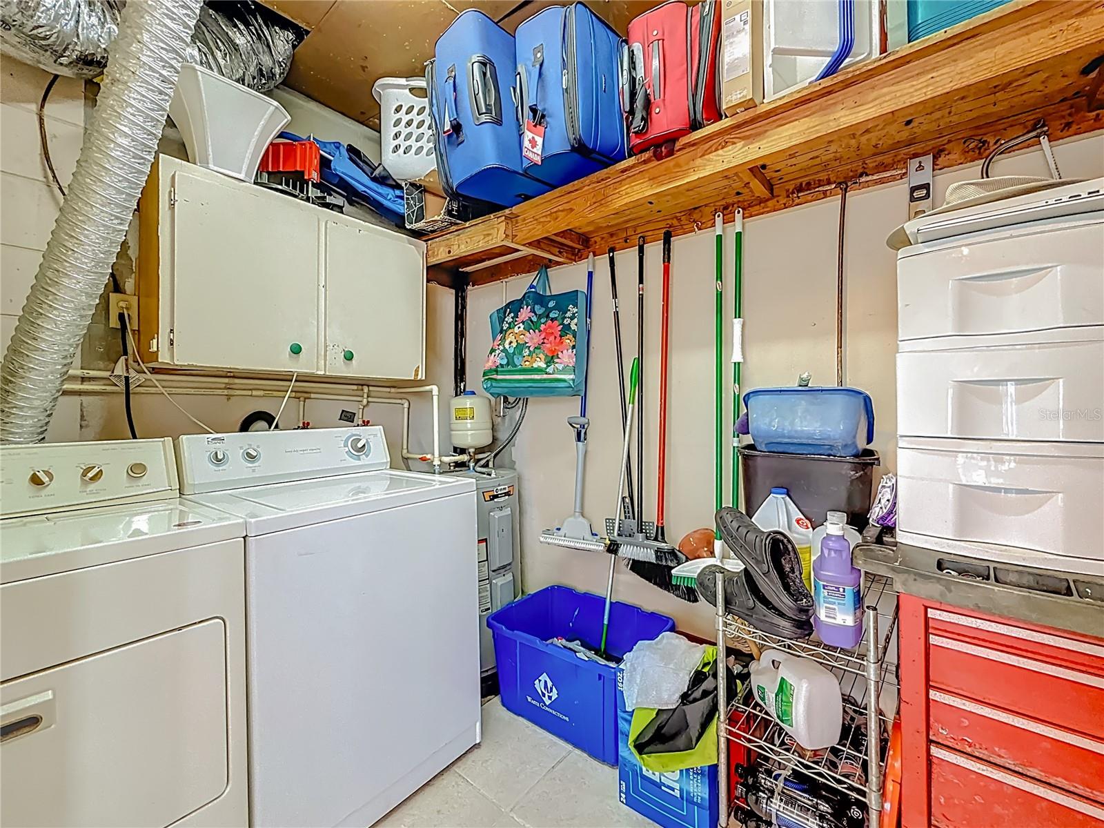 The washer and dryer and water heater are in the closet off of the enclosed side porch.