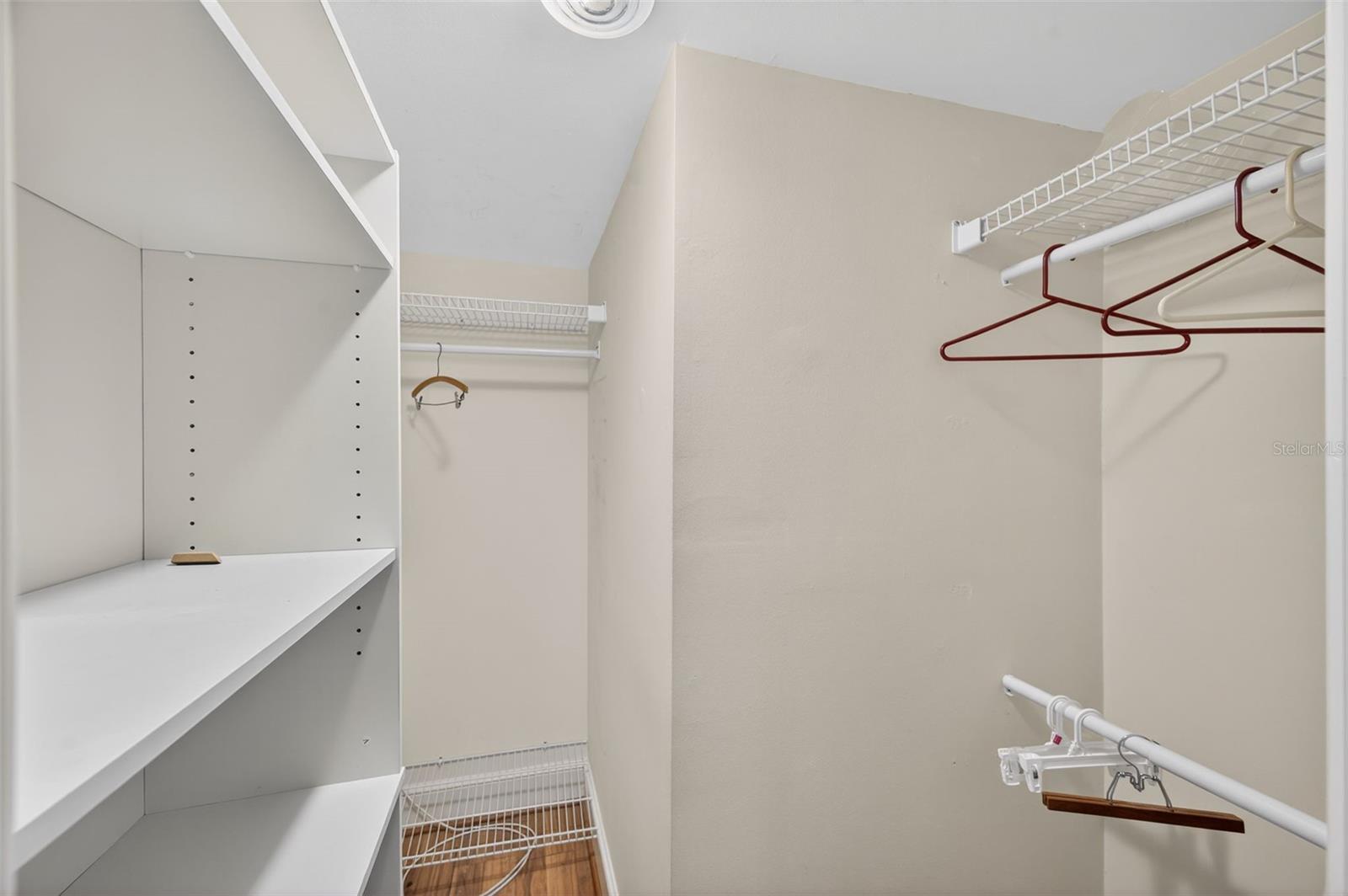 Primary bedroom walk in closet with built in's