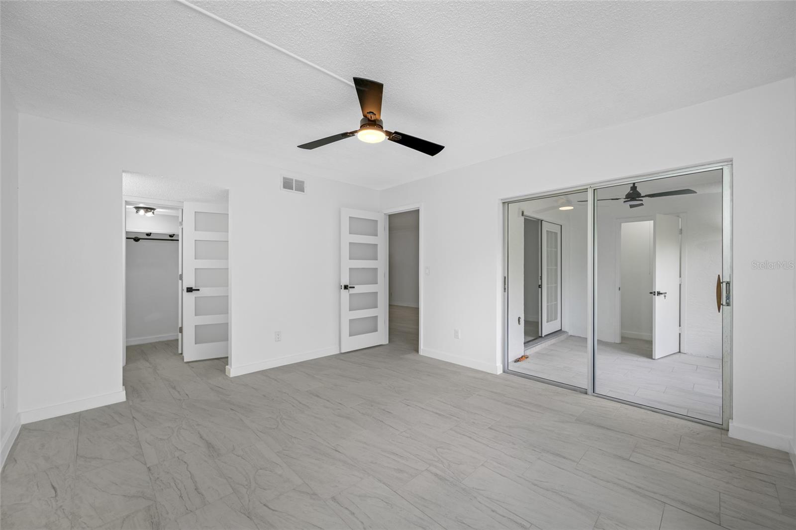 Primary bedroom view of living, lanai, and ensuite  space