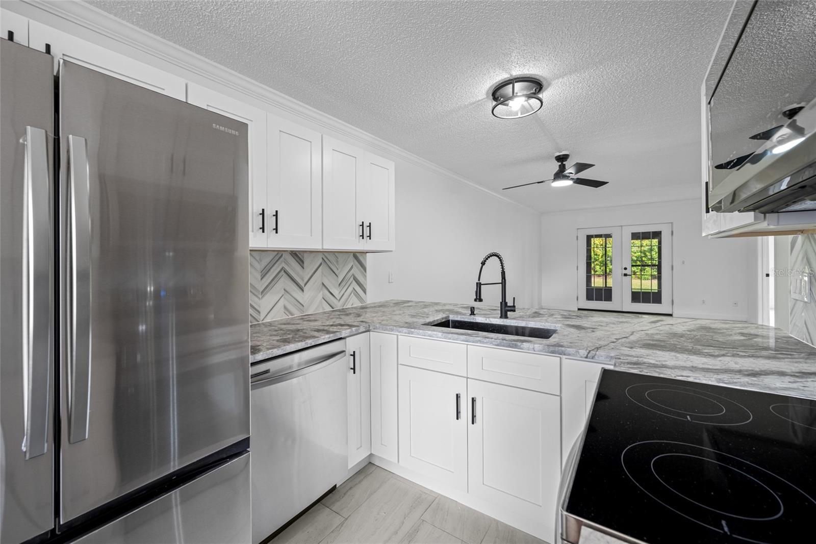 Stainless steel appliances, soft close cabinets, stone countertops.