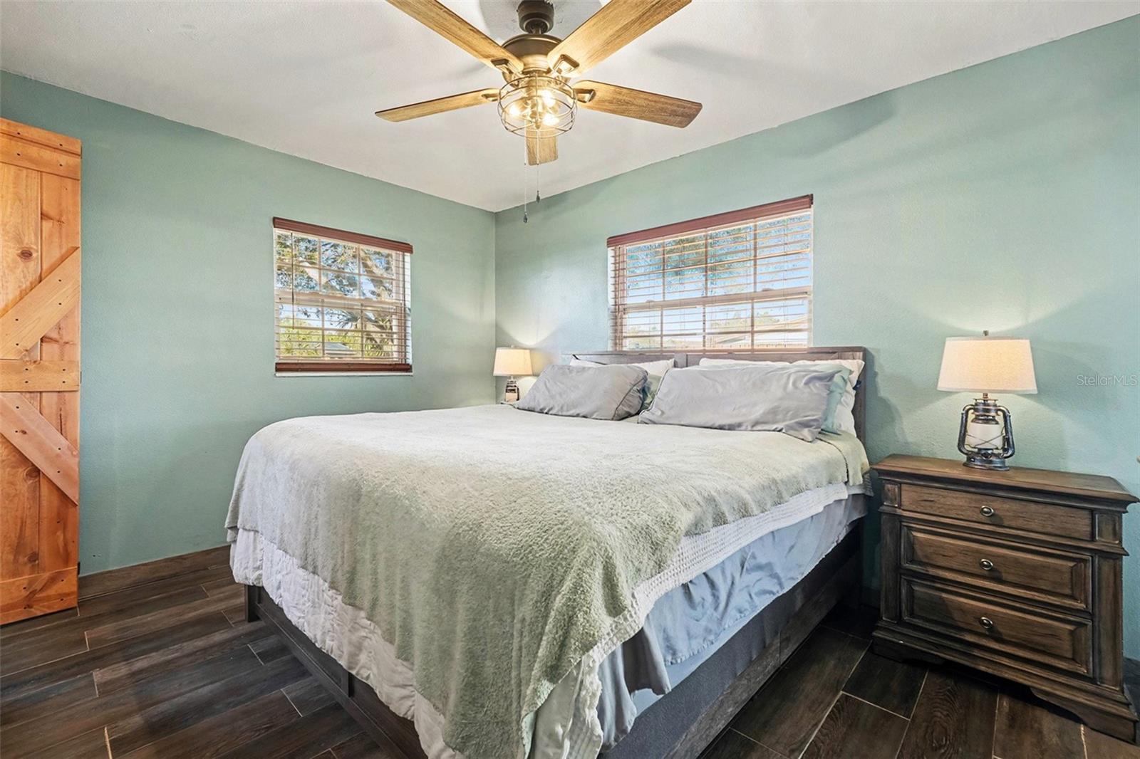 Relaxing primary suite offering a comfortable layout, neutral tones, and charming rustic details throughout