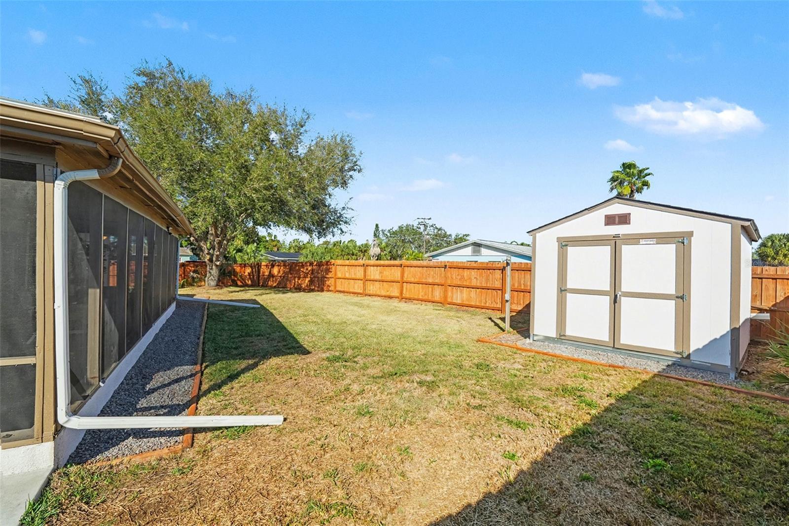 Oversized fenced yard with detached storage shed—perfect for tools, lawn equipment, or hobby storage.