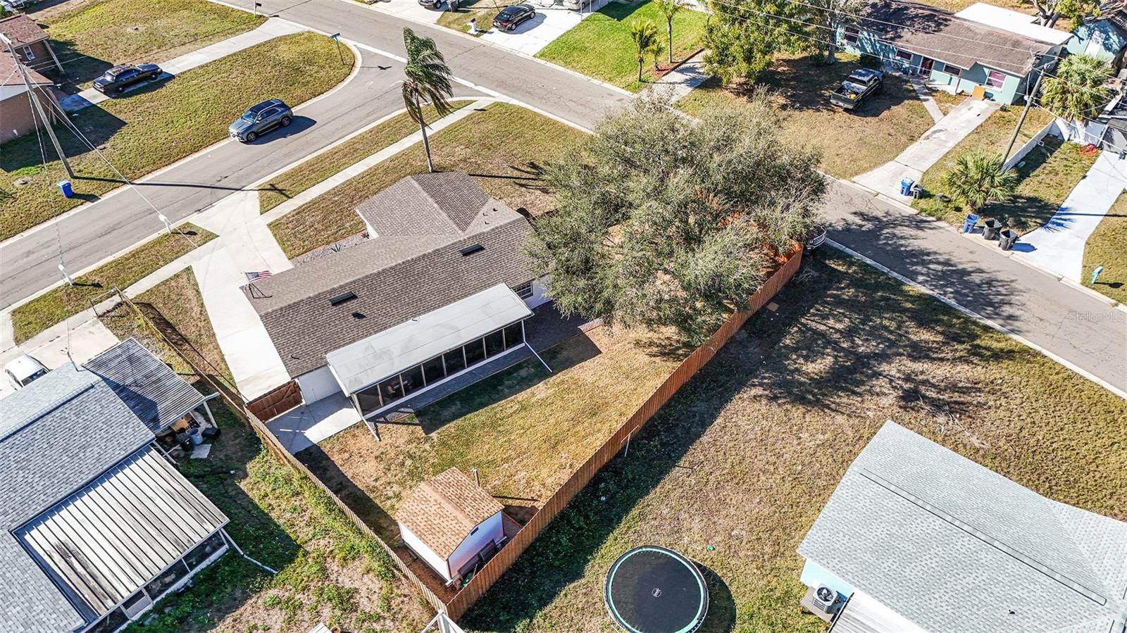 Overhead view showcasing the expansive fenced yard, screened porch, and generous lot size