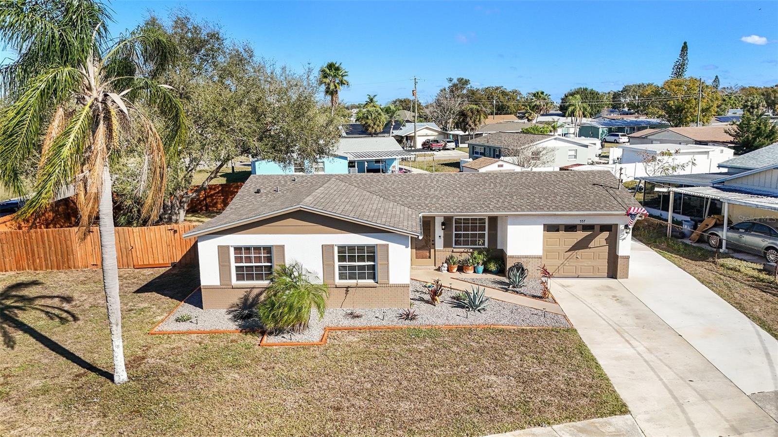 Bird’s-eye view highlighting the generous corner lot, oversized fenced yard, and established neighborhood setting.