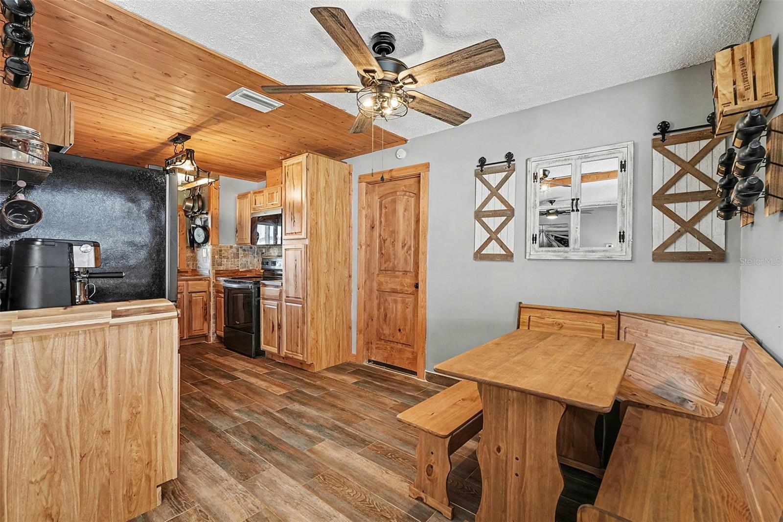 Cozy dining area with custom wood accents, ceiling fan, and natural light—perfect for family meals or casual gatherings