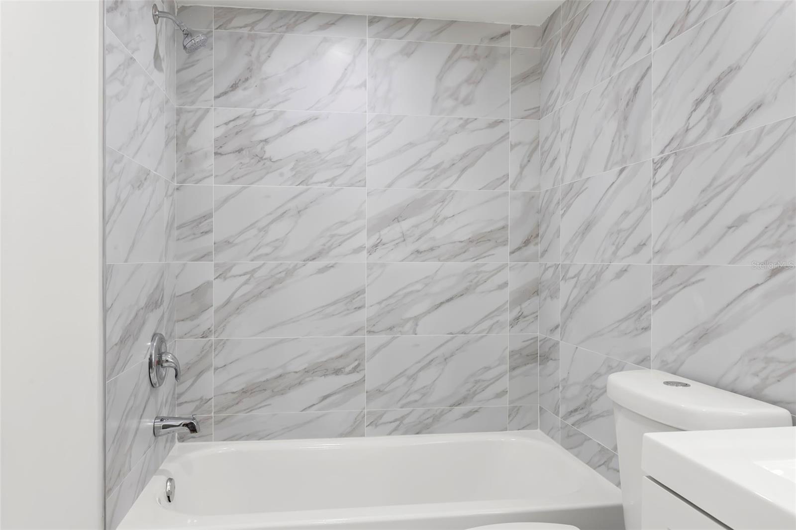 Tub/shower combo in the fully upgraded en suite Guest bath