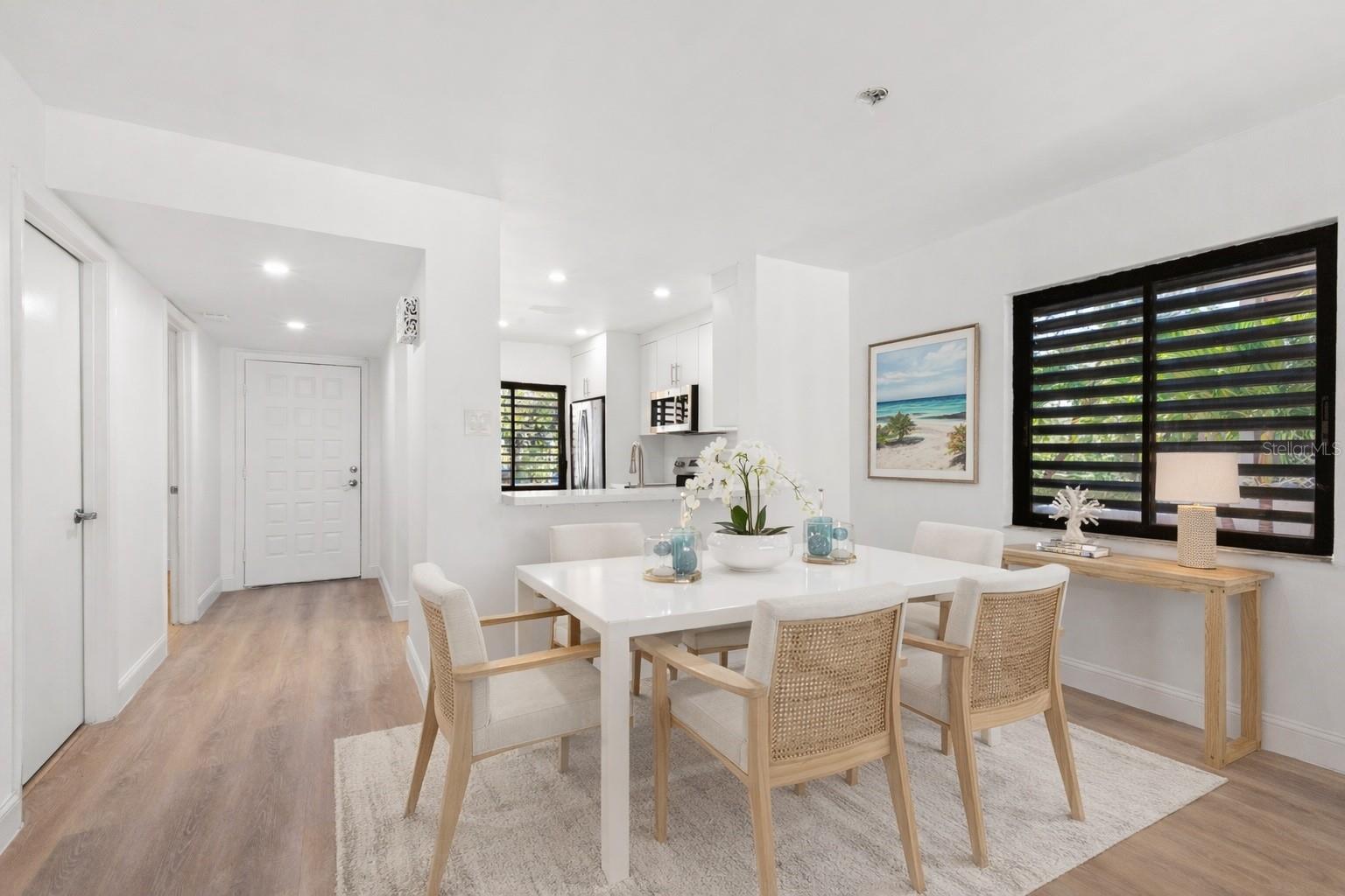 Virtual staging. Dining Room with pass-through bar to kitchen