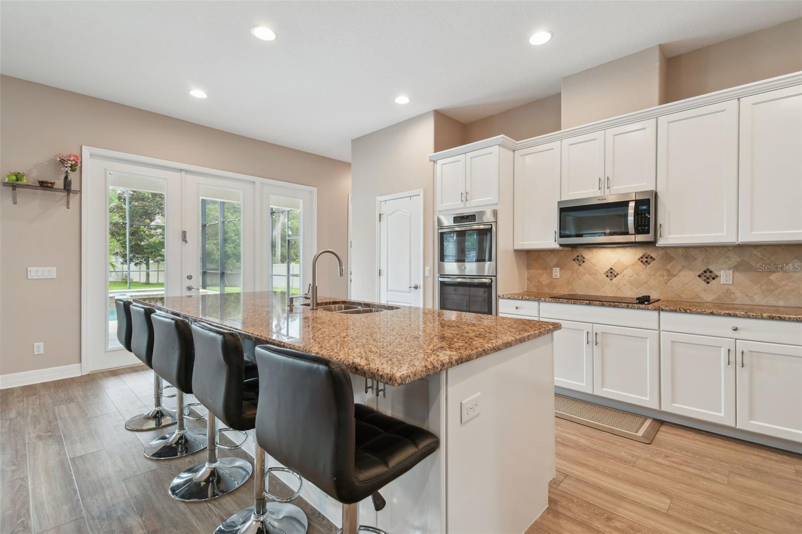 The white cabinets with natural stone counters allow for a nice natural balance.