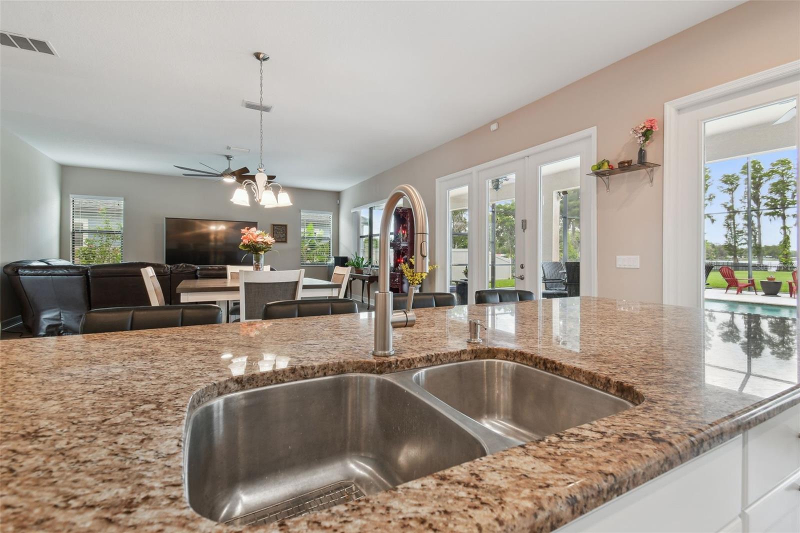 There is an oversized double under-counter stainless steel sink.