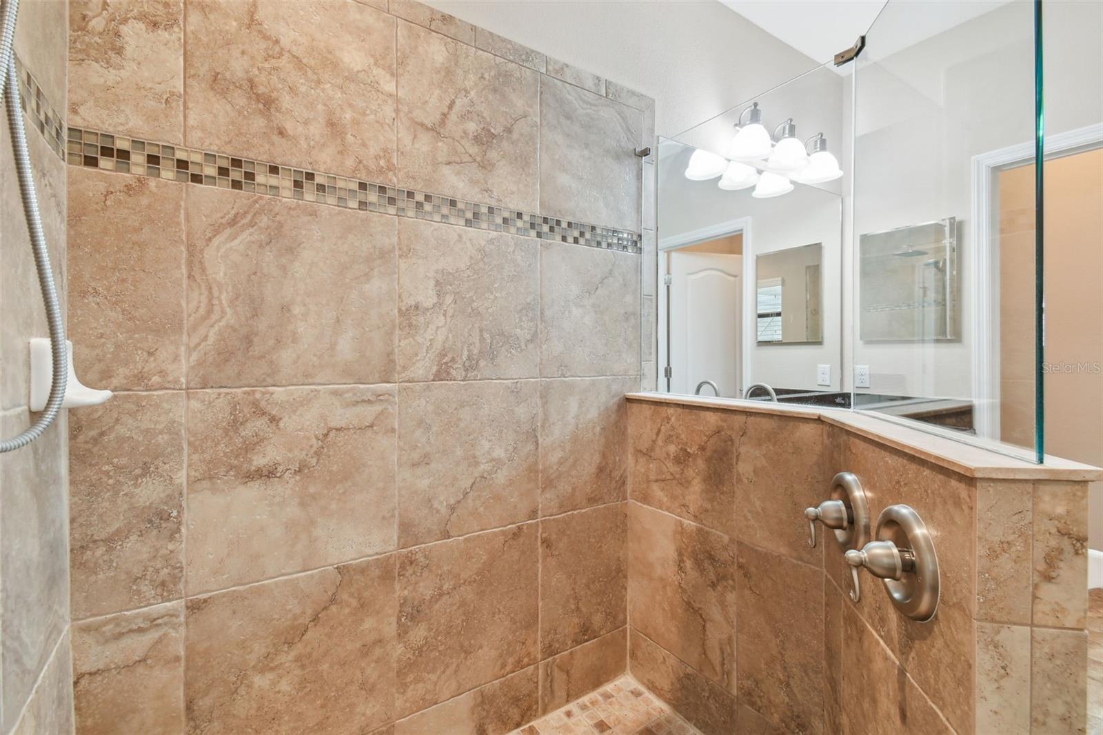 Walk-in shower has wall controls by the entrance for easy and dry access!