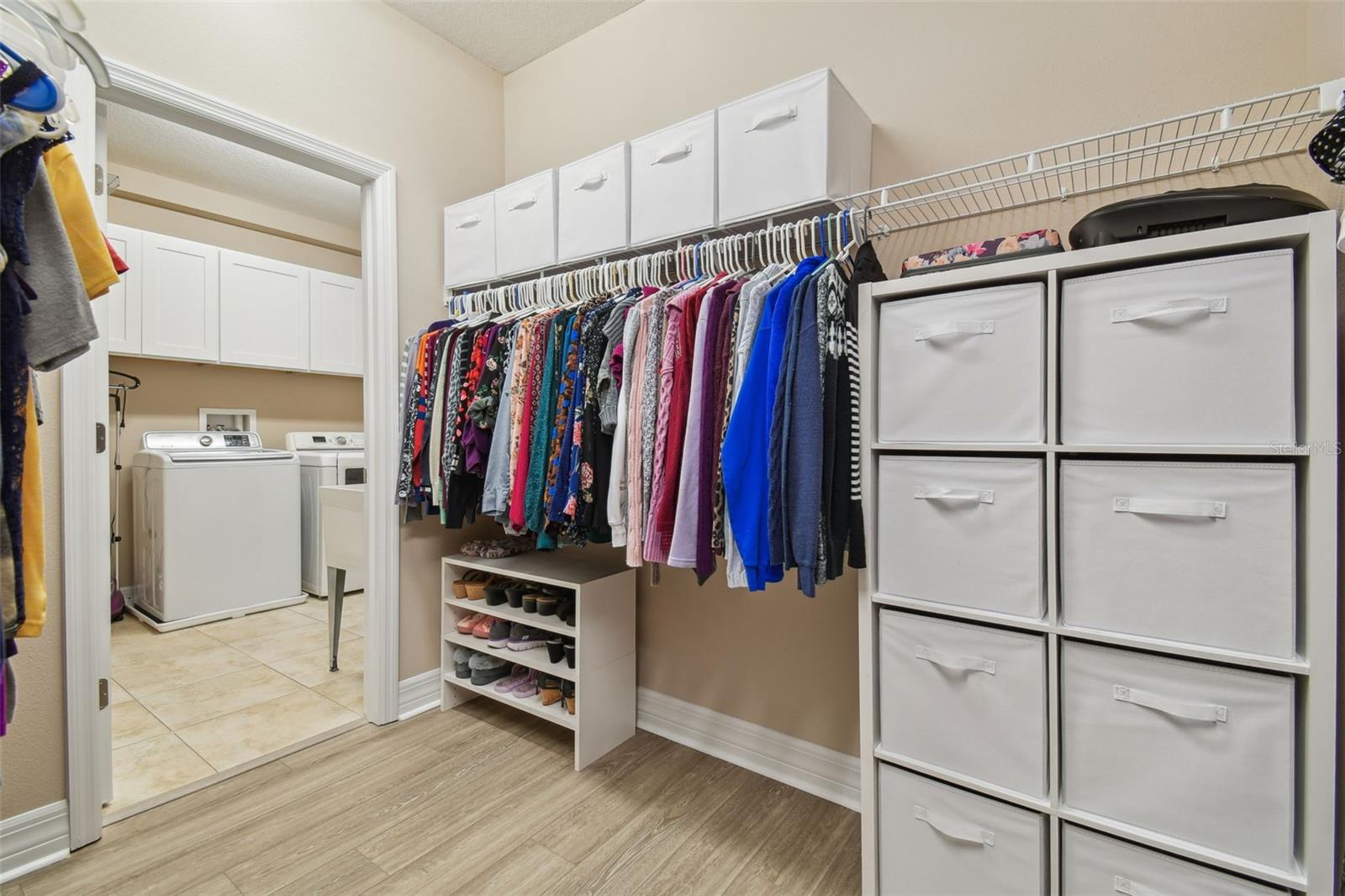 Through one of the oversized walk-in closets, is the laundry room for convenience!