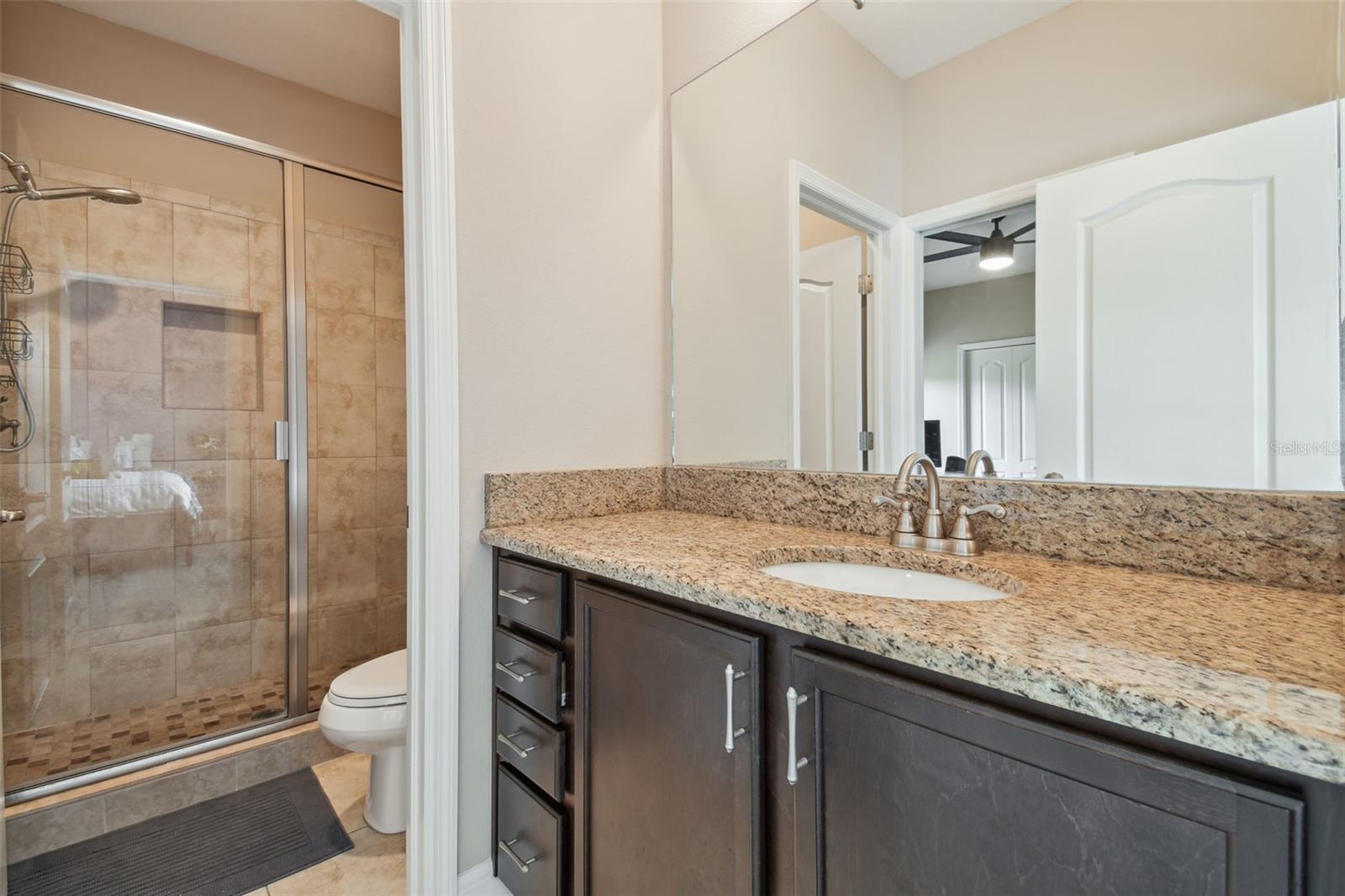 The Jack-n-Jill bathroom has a full walk-in shower.